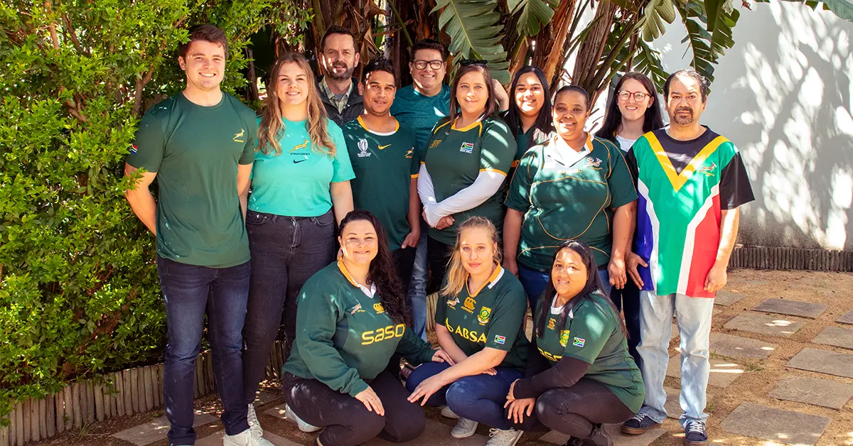 The Trafico team in green branded shirts, posing together outdoors
