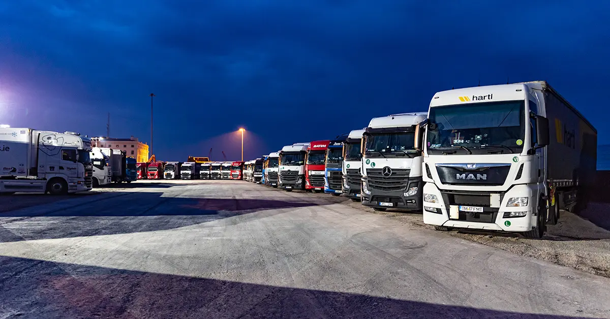 Row of trucks parked at a truck stop at dusk